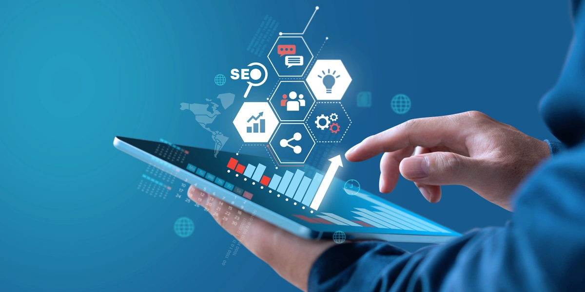Someone's hands holding a tablet with digital-like icons floating around it.
